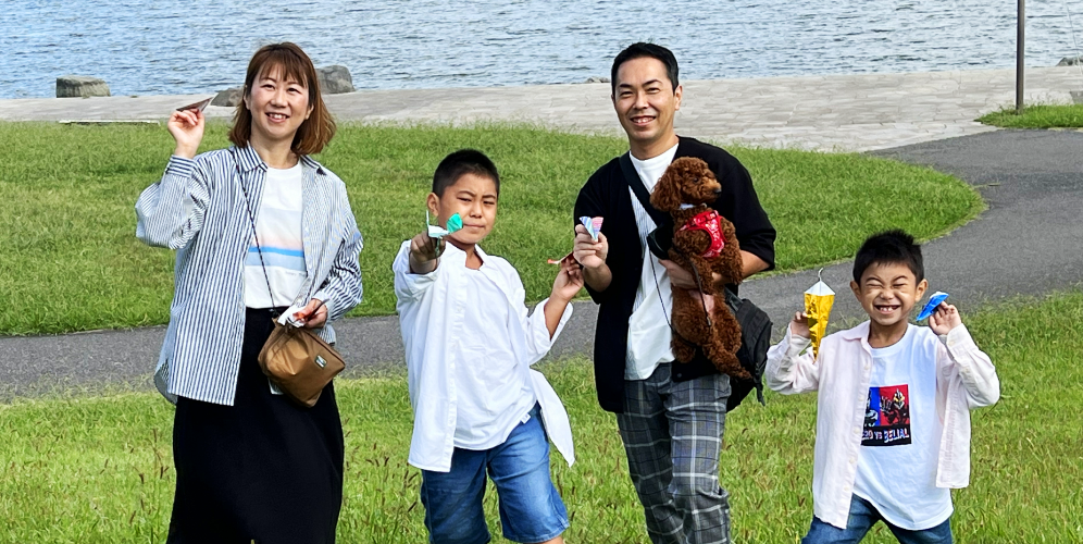 紙飛行機を持つ青木さんご家族